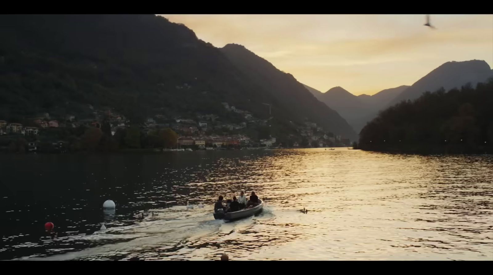 a group of people riding in a boat on a lake