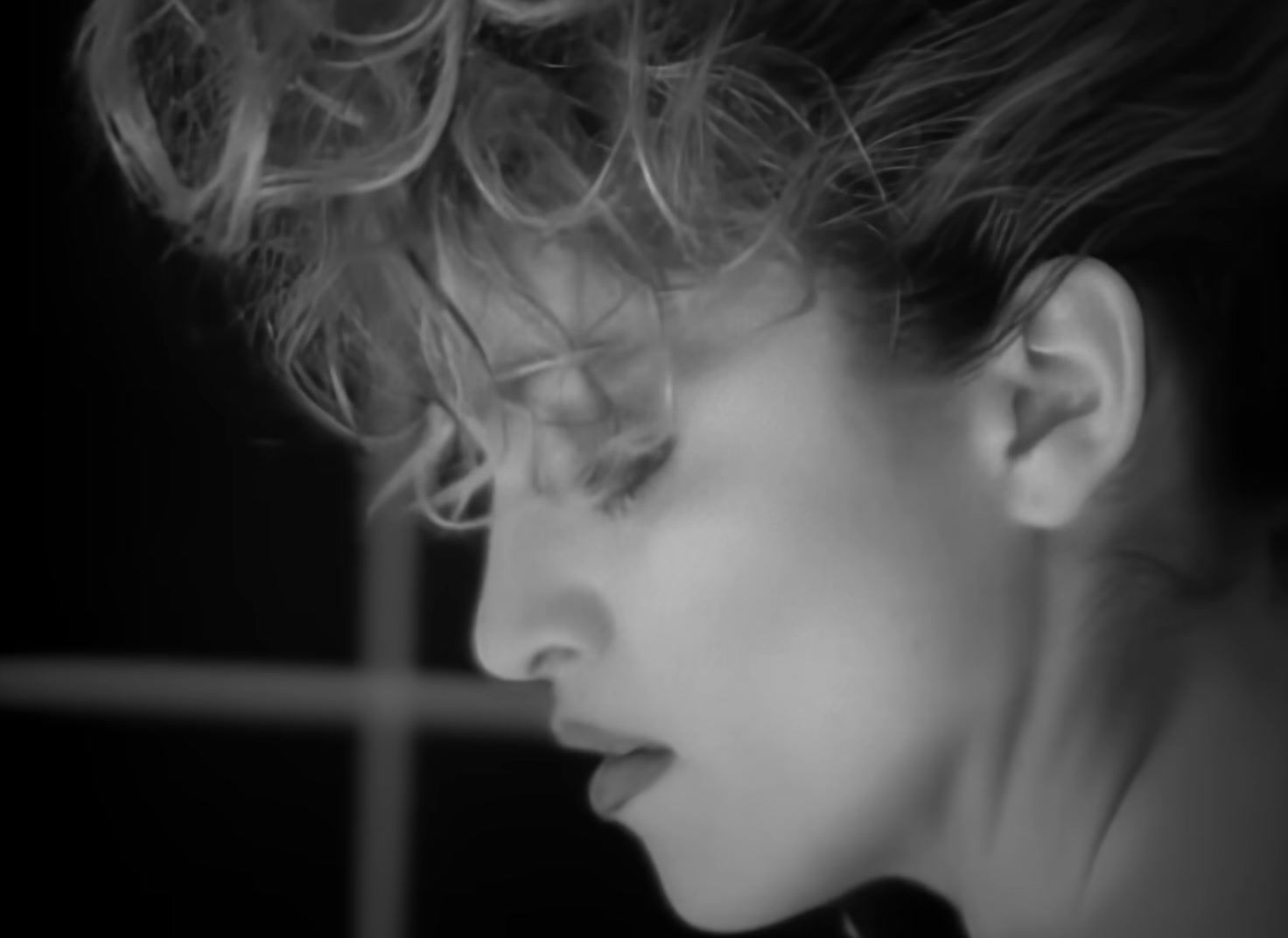 a black and white photo of a woman with curly hair