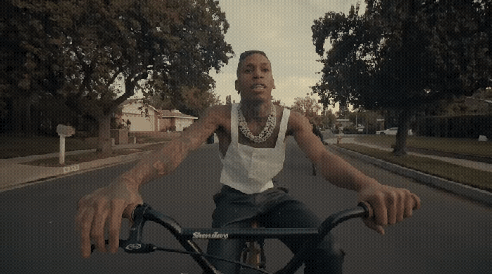 a man riding a bike down a street