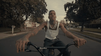 a man riding a bike down a street