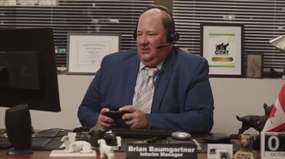 a man wearing a headset sitting in front of a computer