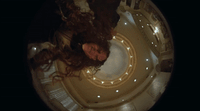 a woman laying down in a circular room