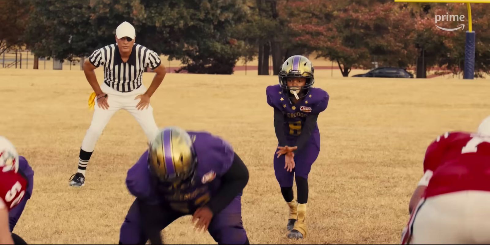 a group of football players standing on top of a field