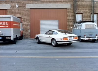 a truck and a van parked in front of a building