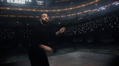 a man in a black shirt is standing in a stadium