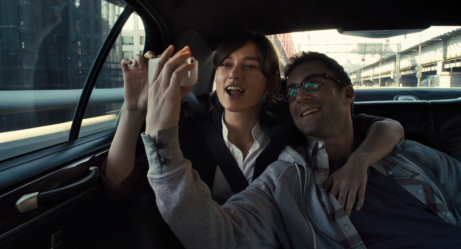 a man and a woman sitting in a car