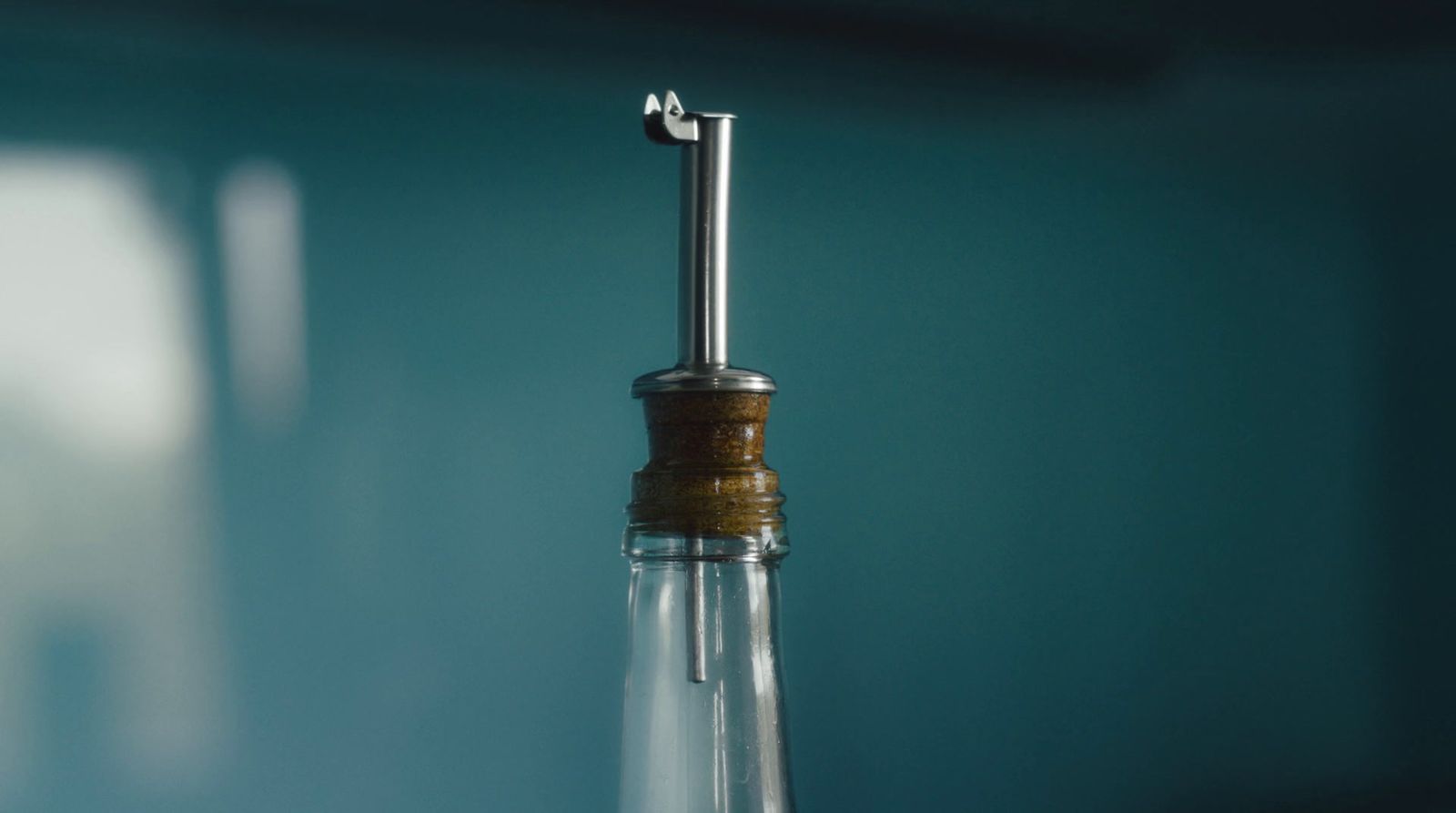 a bottle with a cork in it sitting on a table