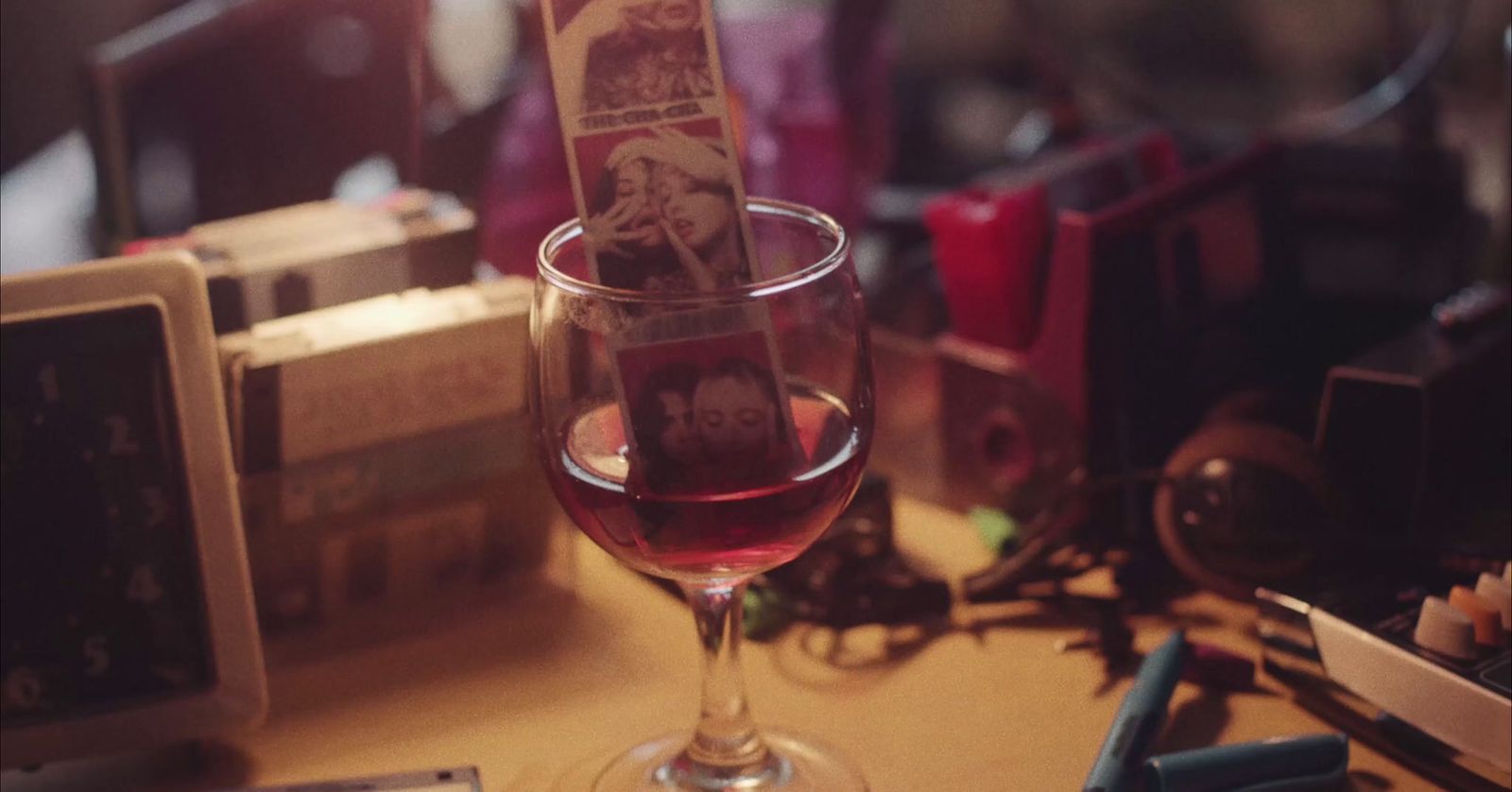 a glass of wine sitting on top of a table