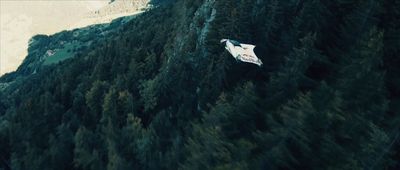 an aerial view of a house in the middle of a forest