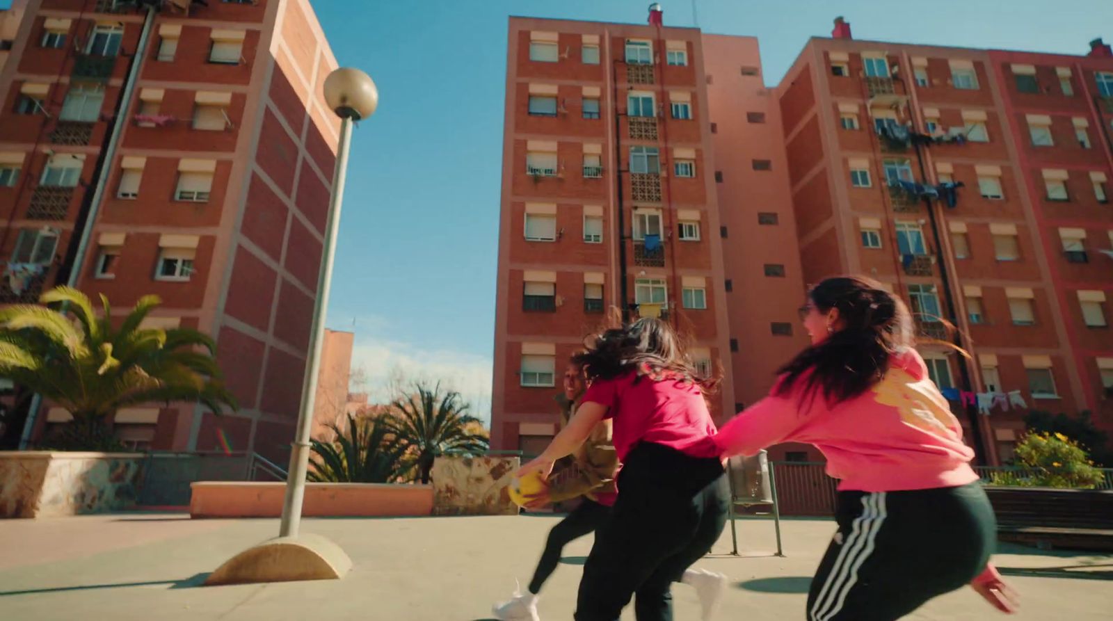 a group of young women playing a game of frisbee