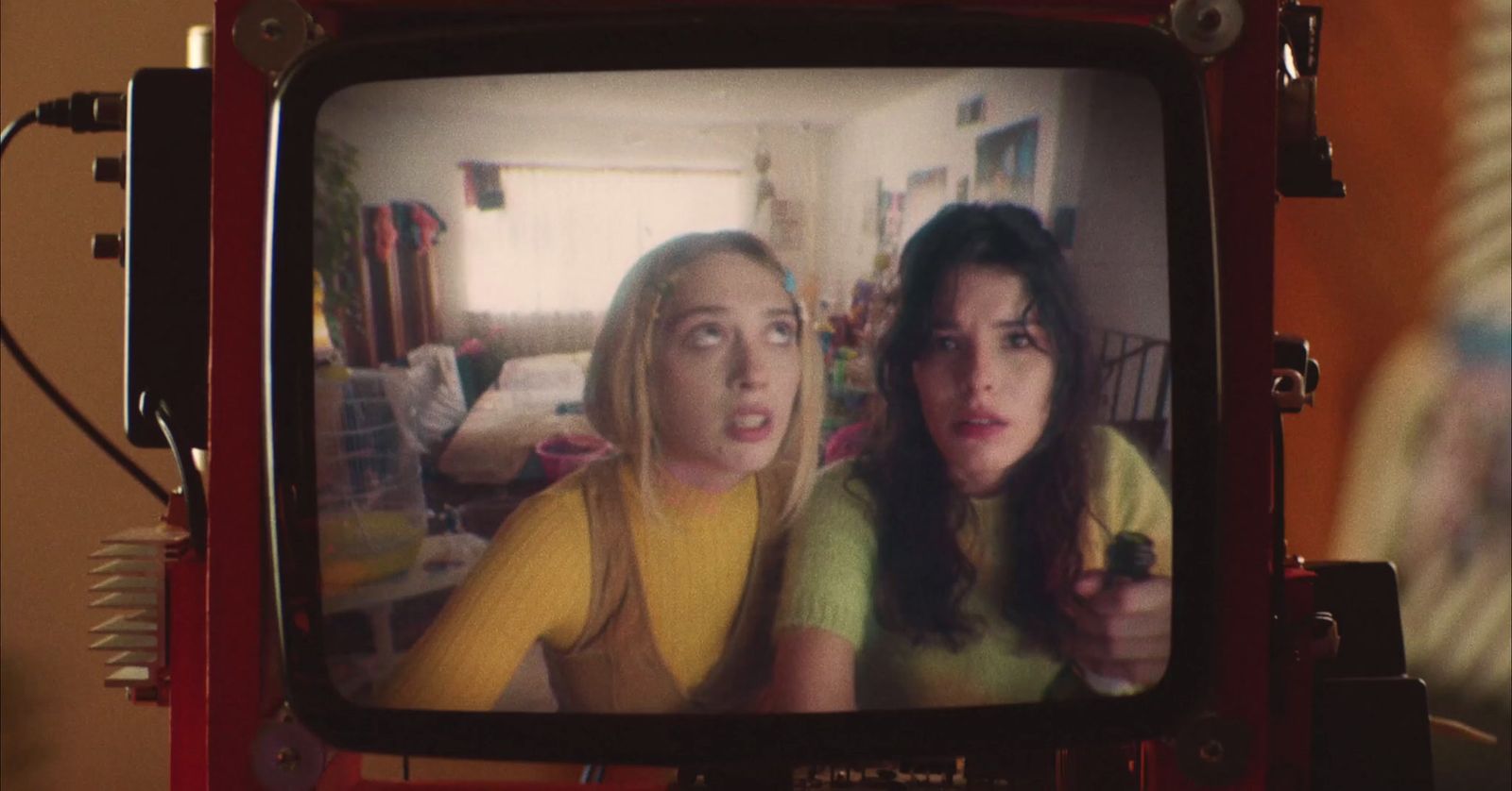 two women on a television screen in a living room