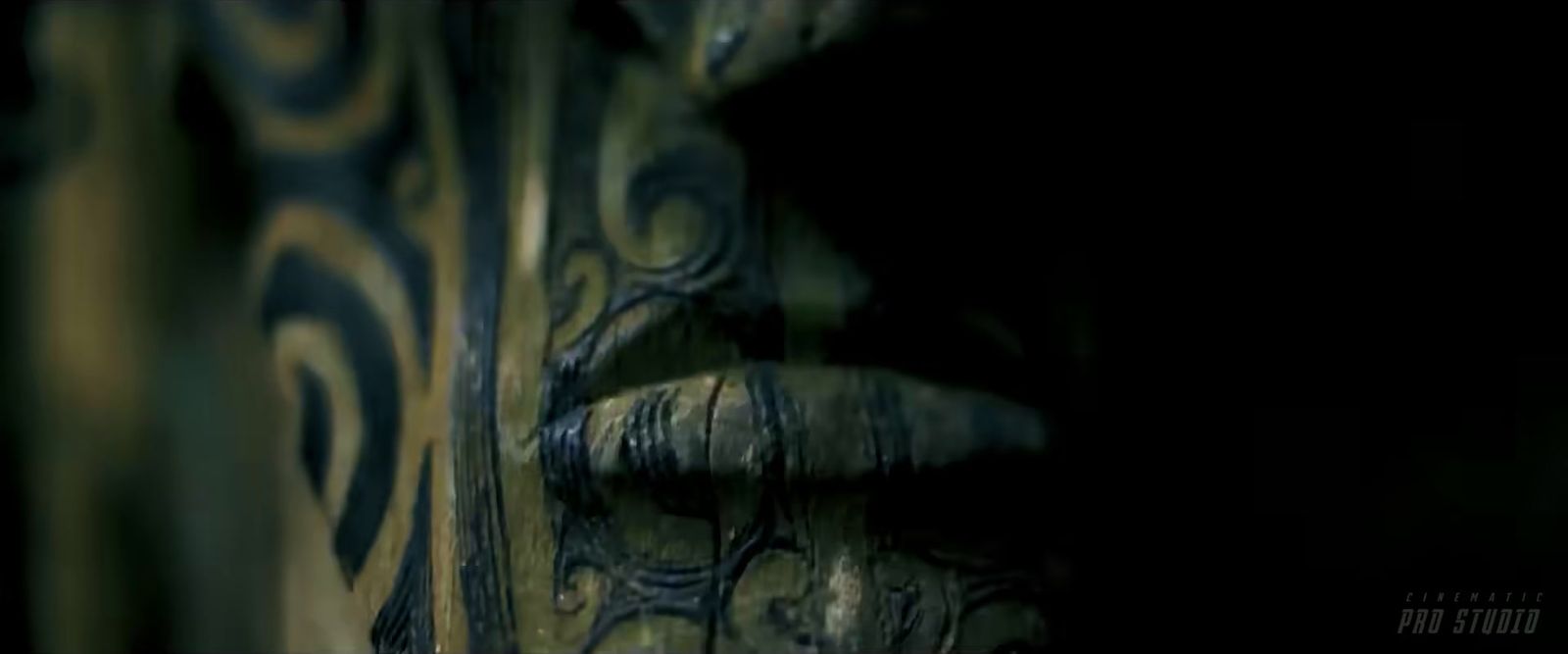 a close up of a wooden carving in the dark