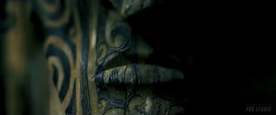 a close up of a wooden carving in the dark