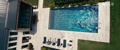 an aerial view of a swimming pool with people in it