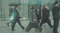 a group of people walking down a street holding umbrellas