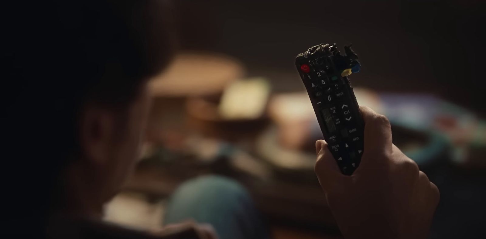 a person holding a remote control in their hand