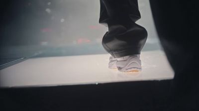 a close up of a person's feet on a white surface