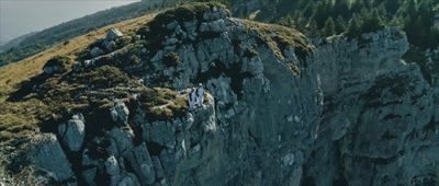 a group of people climbing up the side of a mountain