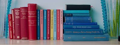 a stack of books sitting on top of a shelf