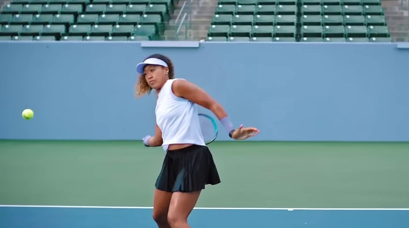 a female tennis player in action on the court