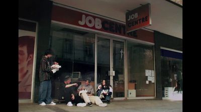 a group of people sitting outside of a job center