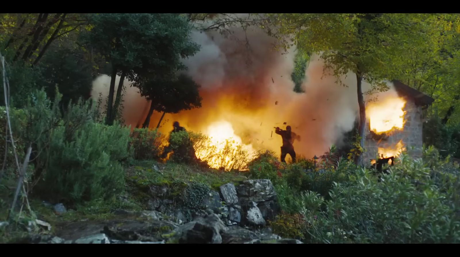 a group of people standing in front of a fire