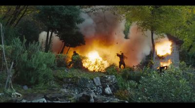 a group of people standing in front of a fire