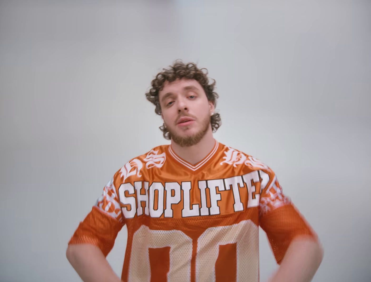 a man in an orange and white uniform holding a frisbee