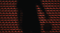 a shadow of a person standing in front of a row of red chairs