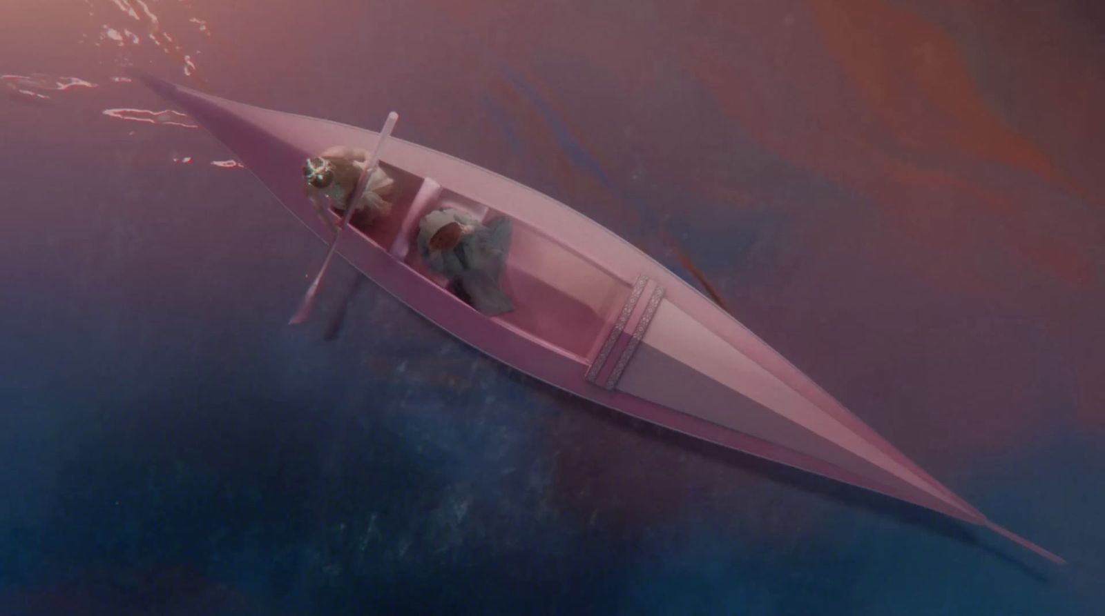 a pink boat floating on top of a body of water