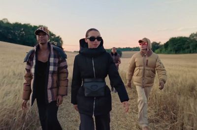 a group of people walking through a field