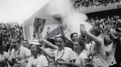 a group of people holding up a trophy