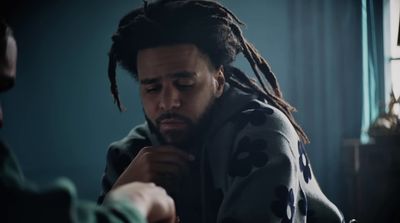 a man with dreadlocks sitting in a room