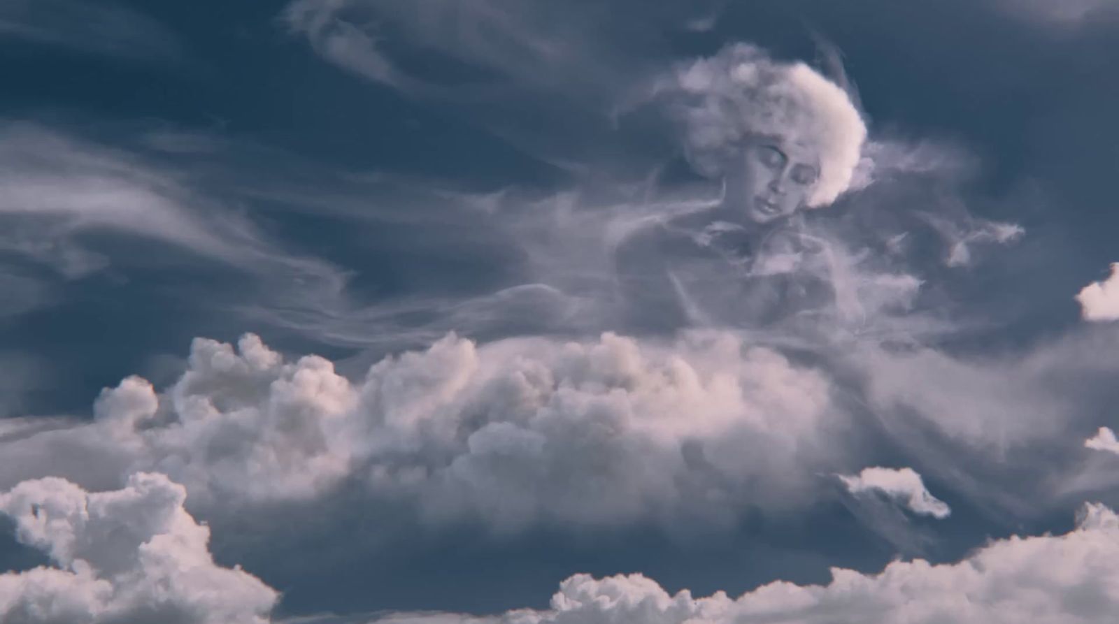 there is a statue in the middle of the clouds