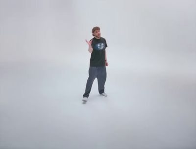 a man standing in the middle of a white room