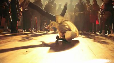 a person riding a skateboard on a wooden floor