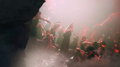 a group of people standing around in a cave