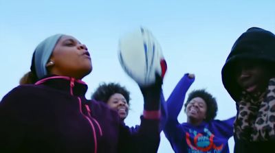 a group of women playing a game of frisbee