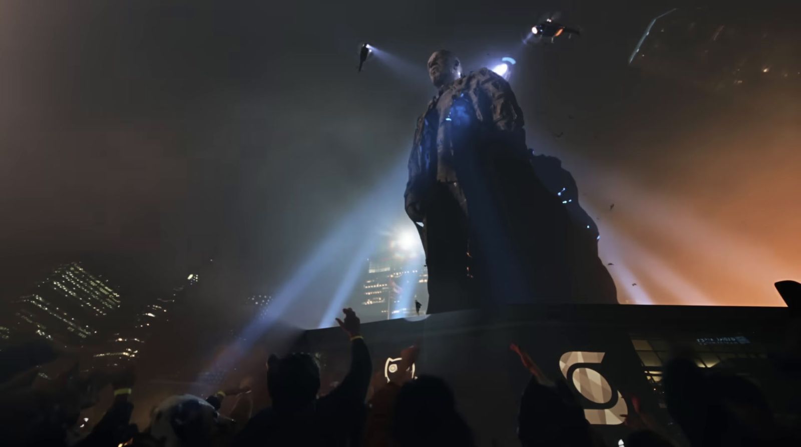 a crowd of people standing around a giant statue