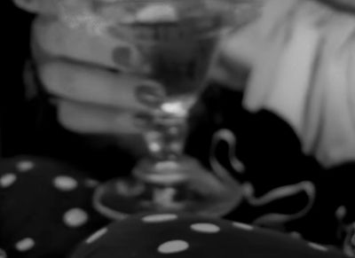 a black and white photo of a person holding a wine glass