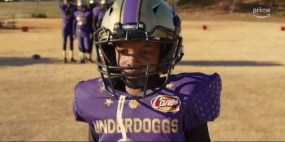 a young boy wearing a football uniform and helmet