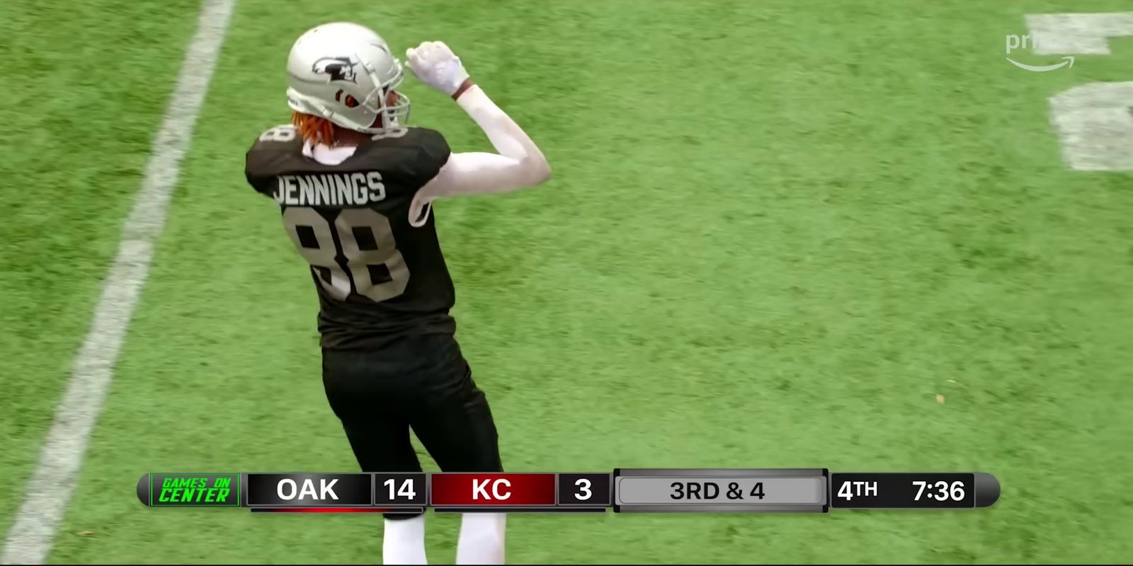 a football player holding a football on top of a field