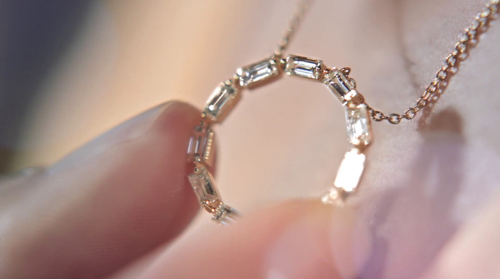 a close up of a person's hand holding a diamond ring