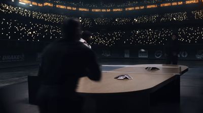 a man sitting at a desk in a darkened room