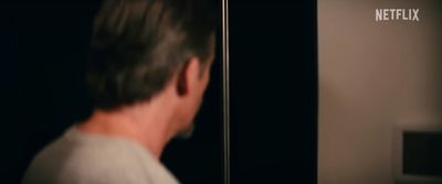 a man looking at himself in the mirror