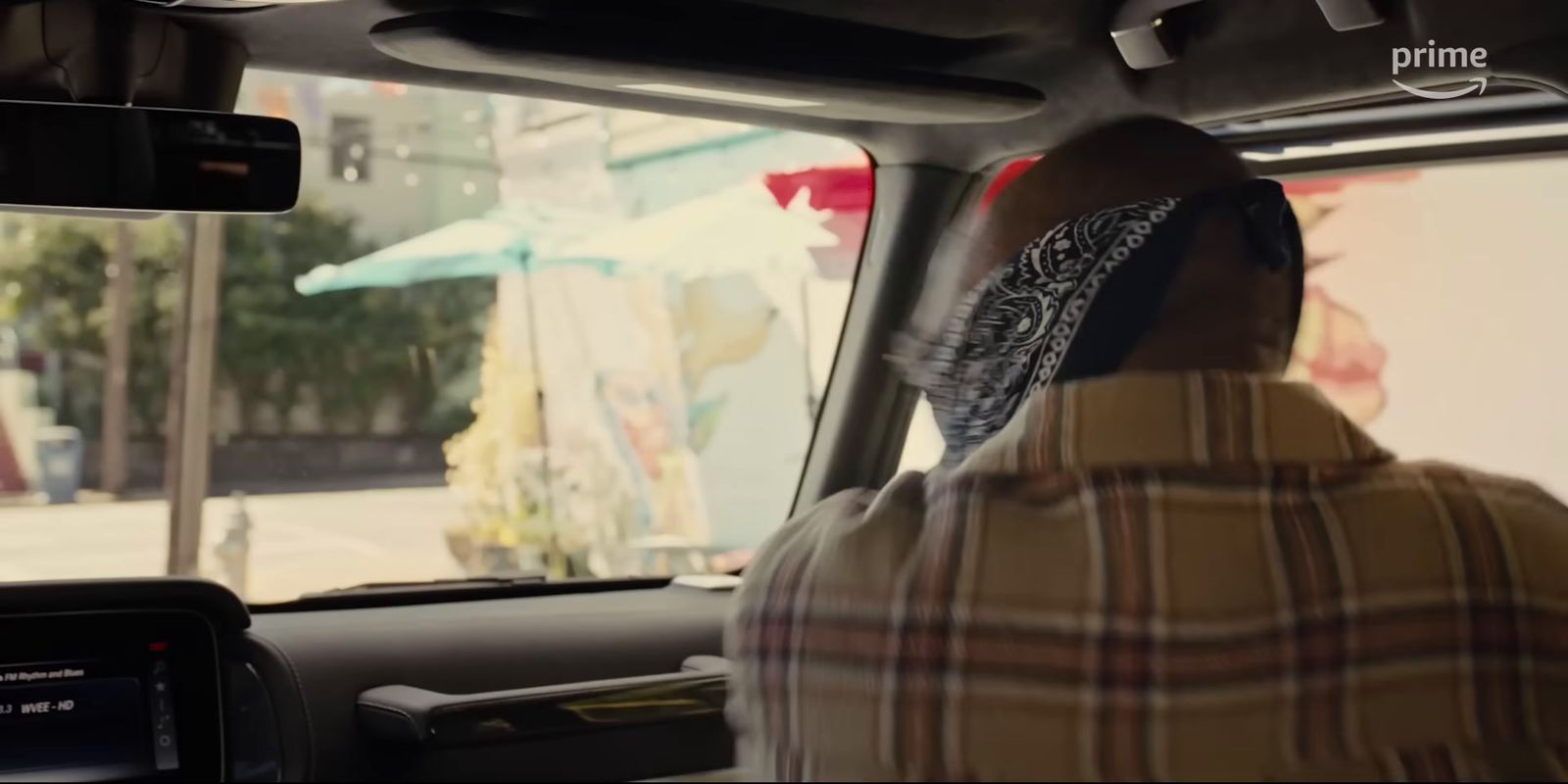 a man driving a car down a street