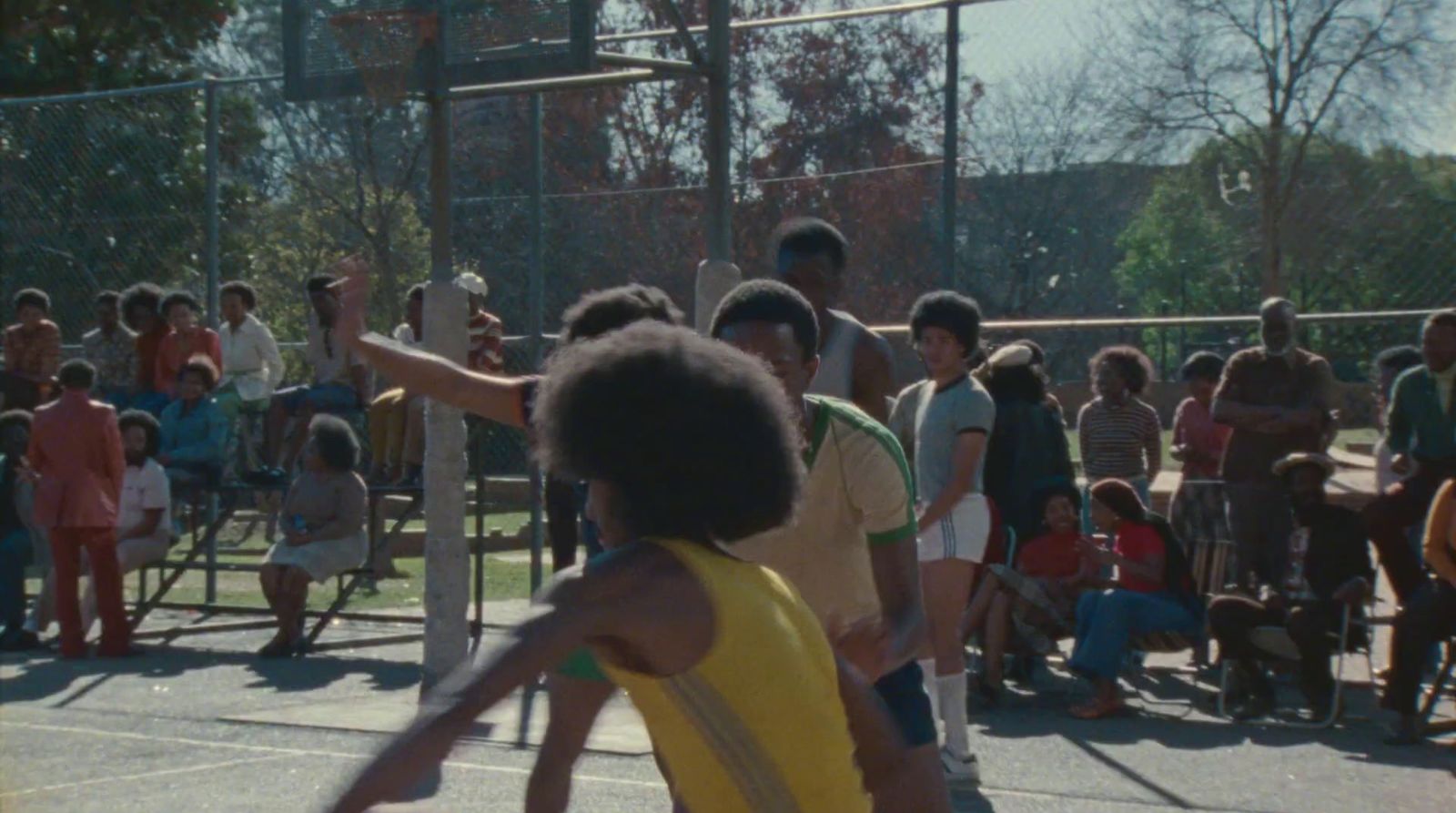 a group of people standing on top of a tennis court