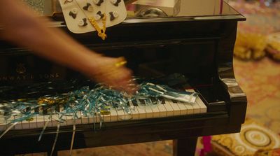 a person is playing a piano with streamers on it