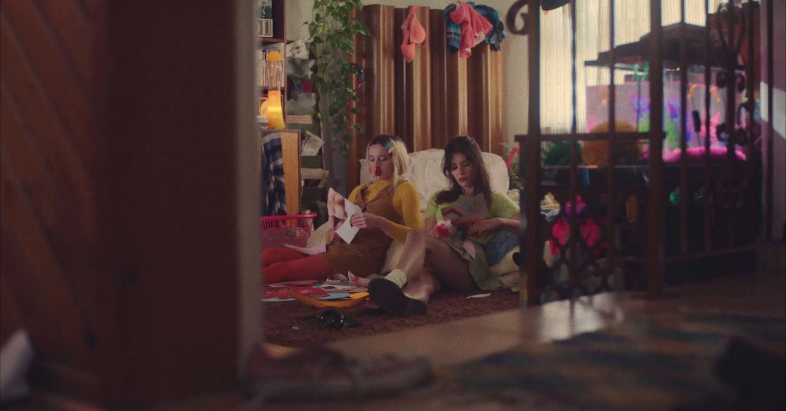 a couple of women sitting on top of a bed