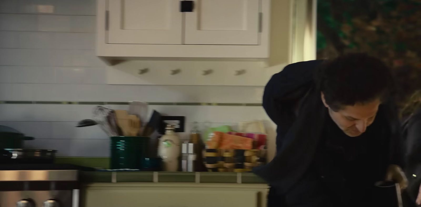 a man standing in a kitchen preparing food